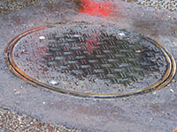 Traffic-Rated Lockable Manhole Covers - 6 (Description: Installation of the traffic rated composite manhole cover is no different than its cast iron counterpart. It’s just lighter and easier to handle.)
